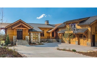 Inspiration for a transitional brown two-story wood exterior home remodel in Salt Lake City with a metal roof