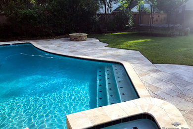 Example of a backyard pool design in Houston with decking