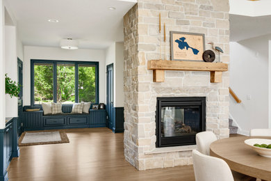 Example of a large transitional medium tone wood floor, beige floor and vaulted ceiling open concept kitchen design in Minneapolis with an undermount sink, shaker cabinets, blue cabinets, quartz countertops, white backsplash, subway tile backsplash, stainless steel appliances, an island and white countertops