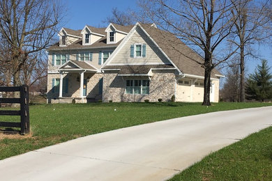 Example of a mid-sized classic beige two-story gable roof design in Other