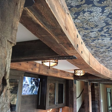 Curved Weathered Antique Beams in a Basement Interior