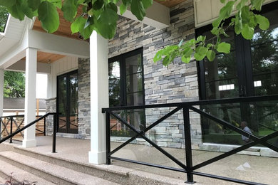 This is an example of a farmhouse front porch design in Calgary.