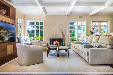 Example of a large mid-century modern open concept dark wood floor and brown floor family room design in Los Angeles with beige walls, a media wall, a standard fireplace, a tile fireplace and a bar