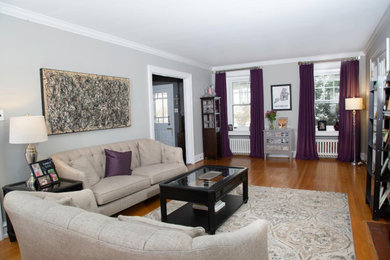 Example of a mid-sized formal and enclosed light wood floor and brown floor living room design in Toronto with gray walls and no tv