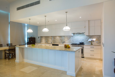 Inspiration for an expansive modern galley kitchen pantry in Brisbane with an undermount sink, shaker cabinets, white cabinets, quartzite benchtops, stone slab splashback, stainless steel appliances, marble floors and with island.