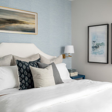 Coastal Inspired Guest Bedroom With Blue Grasscloth Wallpaper And Bedside Sconce