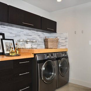 Contemporary utility room in Vancouver with dark wood cabinets.