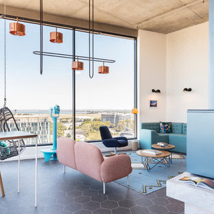 This is an example of an eclectic living room in Sydney with white walls and grey floor.