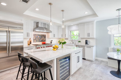 Inspiration for a mid-sized modern gray floor and coffered ceiling enclosed kitchen remodel in San Francisco with a farmhouse sink, shaker cabinets, white cabinets, marble countertops, white backsplash, ceramic backsplash, stainless steel appliances, an island and white countertops