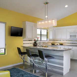Inspiration for a mid-sized midcentury u-shaped eat-in kitchen in Phoenix with recessed-panel cabinets, white cabinets, granite benchtops, metallic splashback, ceramic splashback, porcelain floors and a peninsula.