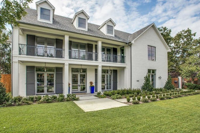 Transitional white two-story brick house exterior idea in Dallas with a shingle roof