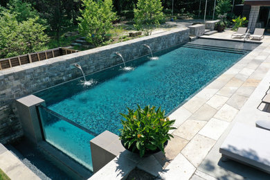 Photo of a mid-sized modern backyard rectangular pool in New York.