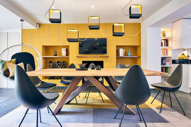 Contemporary open plan kitchen in London with grey floors.