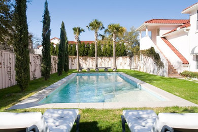Inspiration for a mid-sized contemporary backyard concrete paver and rectangular infinity pool remodel in Dallas