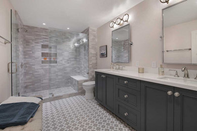 Mid-sized transitional master multicolored tile and porcelain tile porcelain tile, multicolored floor and double-sink bathroom photo in San Francisco with recessed-panel cabinets, black cabinets, a two-piece toilet, beige walls, an undermount sink, quartz countertops, a hinged shower door, white countertops and a built-in vanity