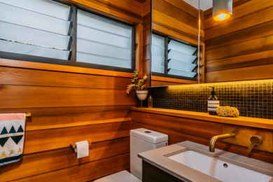 This is an example of a contemporary powder room in Melbourne with a wall-mount toilet, brown walls and ceramic floors.