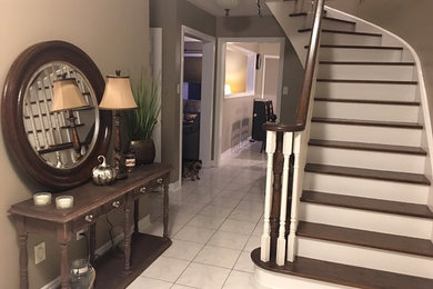 Entry hall - small transitional ceramic tile and white floor entry hall idea in Toronto with gray walls