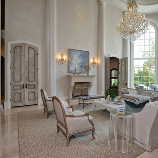 Inspiration for a mediterranean living room in Houston with grey walls, a standard fireplace and grey floors.