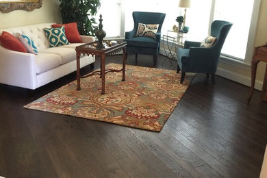 Example of a mid-sized trendy dark wood floor and brown floor living room design in Dallas with yellow walls and no fireplace