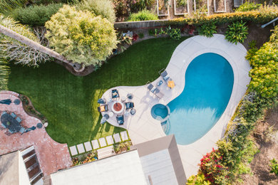 This is an example of a large traditional backyard full sun garden in Santa Barbara with concrete pavers.