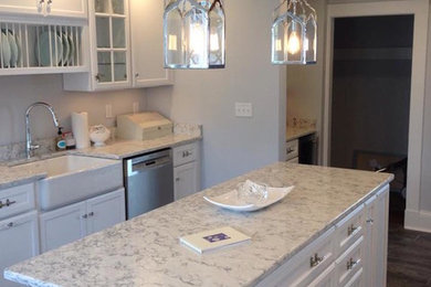 Eat-in kitchen - mid-sized transitional single-wall dark wood floor eat-in kitchen idea in Boston with recessed-panel cabinets, white cabinets, marble countertops, stainless steel appliances and an island