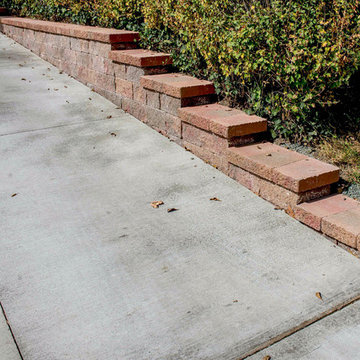 Clean Concrete Drive with Bold Brick Accent Retaining Walls