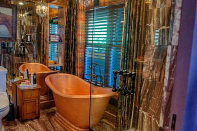 Photo of a large eclectic master bathroom in Seattle with a freestanding tub, a corner shower, multi-coloured tile, stone tile, marble floors, recessed-panel cabinets, dark wood cabinets, a two-piece toilet, brown walls, an undermount sink and marble benchtops.
