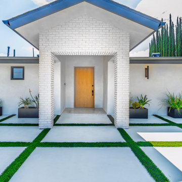 White Brick Entry Portico with a Natural Oak Door