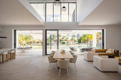 This is an example of a modern open plan dining in Gold Coast - Tweed with white walls and grey floor.