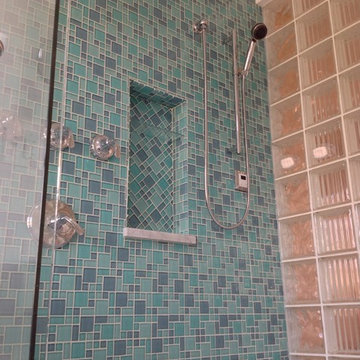 Herringbone glass tile shampoo niche with Argus pattern glass block shower wall