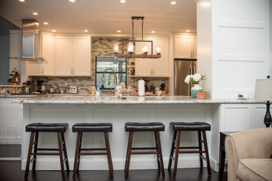 Kitchen - brown floor kitchen idea in Boston with flat-panel cabinets, white cabinets and an island