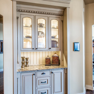 Large mediterranean kitchen pantry ideas - Large tuscan u-shaped dark wood floor kitchen pantry photo in Denver with beaded inset cabinets, beige cabinets, granite countertops, an island, an undermount sink, multicolored backsplash, stone tile backsplash and stainless steel appliances