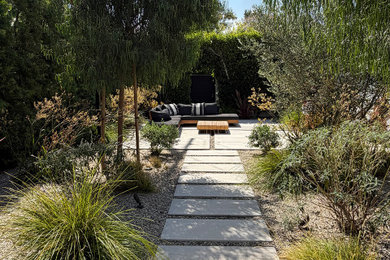 This is an example of a modern drought-tolerant backyard concrete paver landscaping in Los Angeles.