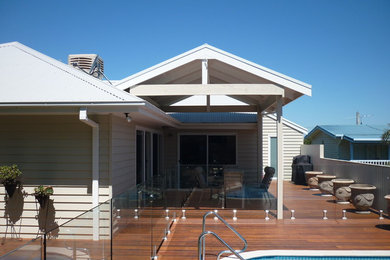 Mid-sized beach style backyard deck in Melbourne with a pergola.