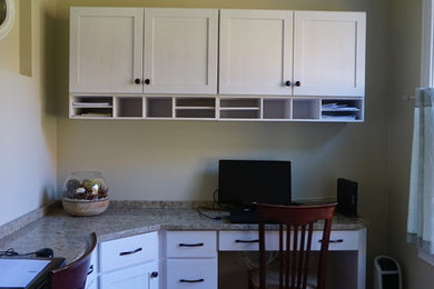 Inspiration for a mid-sized shabby-chic style built-in desk medium tone wood floor study room remodel in Providence with beige walls