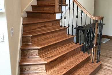 Mid-sized elegant wooden l-shaped metal railing staircase photo in Denver with wooden risers