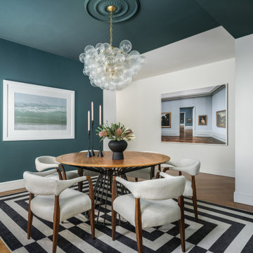 Teal Dining Room with Round Wood Table and Glass Bubble Chandelier