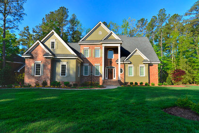 Green three-story brick gable roof photo in Other