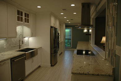 Example of a mid-sized country porcelain tile and gray floor eat-in kitchen design in Jackson with a farmhouse sink, shaker cabinets, white cabinets, granite countertops and stainless steel appliances