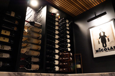 Small modern wine cellar in Brisbane with light hardwood floors and beige floor.