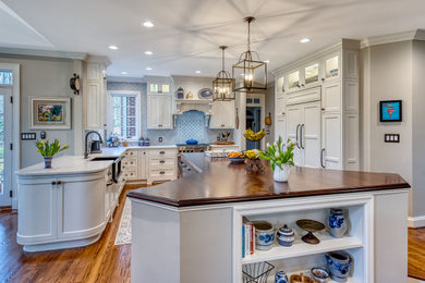 Example of a mid-sized french country kitchen design in DC Metro with a farmhouse sink, shaker cabinets, white cabinets and quartz countertops