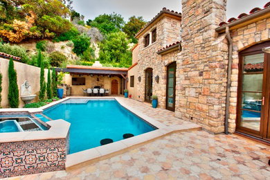 Example of a cottage chic pool design in Orange County