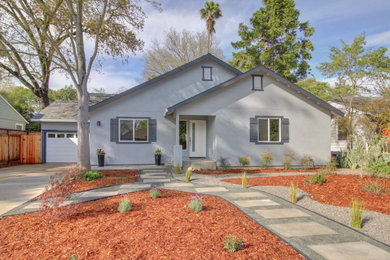 Example of a large trendy blue one-story stucco house exterior design in Sacramento with a shingle roof