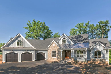 Mid-sized cottage gray mixed siding gable roof idea in Other