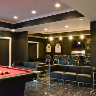 Inspiration for a large modern basement in Charlotte with black walls and black floors.