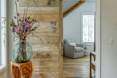 Inspiration for a large transitional loft-style light wood floor living room remodel in Atlanta with a bar, gray walls and a wall-mounted tv