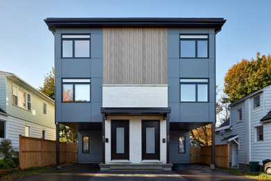 Danish multicolored three-story concrete fiberboard exterior home photo in Ottawa with a mixed material roof and a black roof