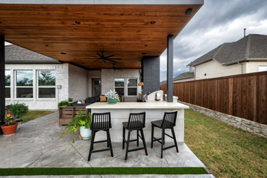 Inspiration for a huge modern backyard stamped concrete patio remodel in Dallas