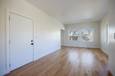 Living room - large contemporary open concept light wood floor and brown floor living room idea in San Francisco with white walls