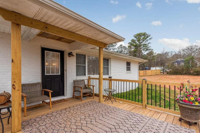 This is an example of a contemporary wood railing front porch design in Charlotte.